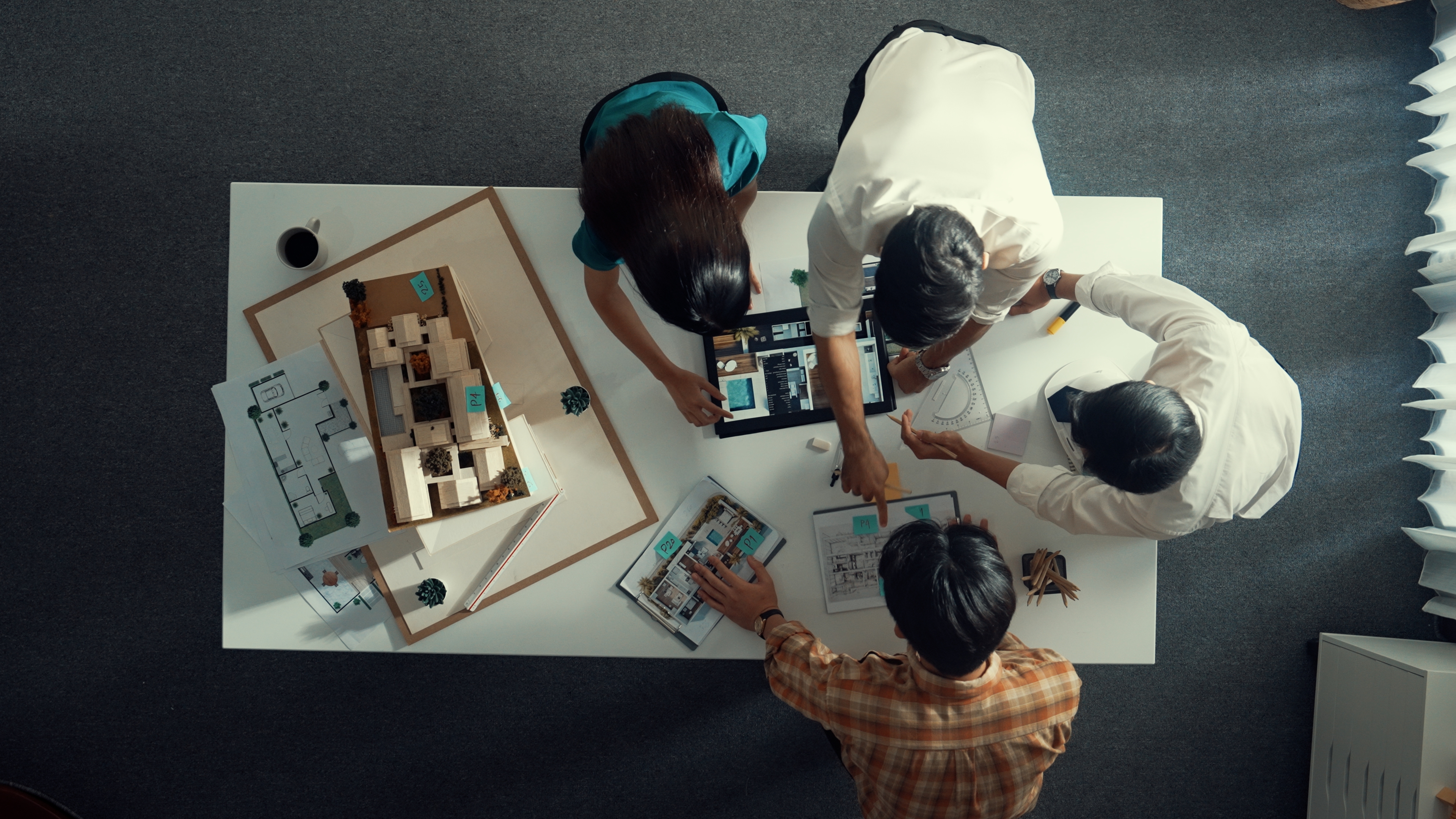 top down view of architect team discussing and pointing at tablet. alimentation.